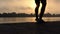 Male Legs Dance on an Impressive Riverbank at a Splendid Sunset in Slo-Mo