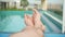 Male legs on the day by the swimming pool. background blur