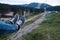 Male legs in jeans in the air. Flying up the hill in the Carpathian mountains. Feet in shoes riding the chairlift or at a popular