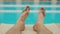 Male legs relaxing near pool