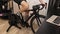 Male legs are spinning pedals on exercise bicycle at home. Professional cyclist is cycling on indoor cycling trainer. Indoor cycli