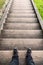 Male legs stand on old wooden stairs