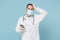 Male on-line doctor man in medical gown sterile face mask gloves isolated on blue background. Epidemic pandemic