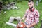 Male lumberjack with chainsaw cutting wood and timber