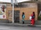 MALE, MALDIVES - NOVEMBER 7, 2019: Women in national clothes at the bus stop in the city of Male