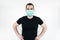 Male man young black t-shirt stand white background wear mask on face.   protect yourself. save life coronavirus symbol