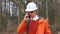 A male manager at the cash desk talking on the phone at a logging site.