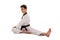 Male martial artist stretches, full length on white background