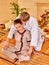 Male masseur doing massage woman in bamboo spa