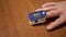 Male Measures Pulse and Oxygen Saturation Using a Pulse Oximeter at Home