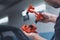 A male mechanic assembles a car brake caliper. A man holds auto parts in his hands in a car service