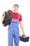 Male mechanic carrying tires and holding toolbox