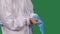 Male medical worker professional in a white protective suit puts on blue surgical gloves. Torso and hands man close up