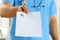 Male medicine doctor in blue uniform hold and give prescription