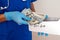 Male medicine doctor holding in hands bunch of hundred dollars banknotes counting them. Concept of corruption in