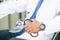 Male medicine therapist doctor hands holding stethoscope in office closeup. Physician is waiting for patient to examine.