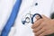 Male medicine therapist doctor hands holding stethoscope in office closeup. Physician is waiting for patient to examine.