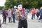 A male mime with a soft raccoon toy at the Bright people festival in Gorky Park on city Day