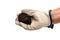 Male miner hand holding coal, black rock or raw graphite, mining or geology concept.  white background