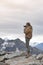 Male model posts at the top of snowcapped mountain peak around Aoraki Mount Cook and Mount Cook National Park