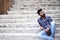 Male model sitting stairs looking up Sion fort, Mumbai