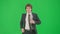 Male model in suit isolated on chroma key green screen background. Positive young businessman in blue suit running fast.
