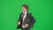 Male model in suit isolated on chroma key green screen background. Positive young businessman in blue suit running fast.
