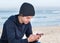 Male model wearing dark grey knitted beanie with Bluetooth speakers inside