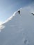 Male mountain climber on his way to a high summit in the Alps after exiting a hard north face climbing route