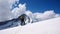 Male mountain climber looks towards the summit and his goal while standing o n a high alpine glacier