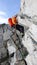 Male mountain climber rappelling off a steep rocky ridge in the French Alps near Chamonix