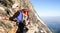 Male mountain climber on a steep rock face on his way to the famous Eiger mountain in the Swiss Alps near Grindelwald