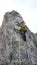 Male mountain guide lead climbing on an exposed granite ridge in the Alps
