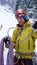 Male mountain guide preparing to climb a steep frozen waterfall on a cold winter day in the Alps