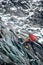 Male mountaineer climbing rocky mountain.