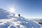 A male mountaineer walking uphill on a glacier. Mountaineer reac