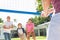 Male Multi Generation Family Playing Volleyball In Garden