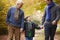 Male Multl Generation Family Walking Along Autumn Path