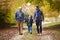 Male Multl Generation Family Walking Along Autumn Path