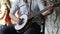 Male musician playing banjo sitting chair indoor