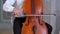 A male musician plays the cello. Panorama