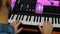 Male musician songwriter playing piano midi keyboard. Sound engineer working on digital audio workstation. Man hands plays piano i