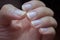Male nails are clean, but long nails can be a source of germs. Should be cleaned, men`s hands have long nails on a black backgrou
