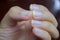 Male nails are clean, but long nails can be a source of germs. Should be cleaned, men`s hands have long nails on a black backgrou