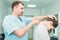 Male neurologist doctor examines cervical vertebrae of female patient spinal column in medical clinic. Neurological physical exami