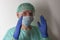 Male nurse, with plastic protective eyeglasses and face mask , cap, gown, gloves,  with  personal protective equipment to protect