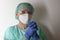 Male nurse, with plastic protective eyeglasses and respirator ffp2, cap, gown, gloves,  with  personal protective equipment to