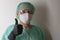 Male nurse, with plastic protective eyeglasses and respirator ffp2, cap, gown, gloves,  with  personal protective equipment to