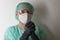 Male nurse, with plastic protective eyeglasses and respirator ffp2, cap, gown, gloves,  with  personal protective equipment to