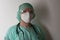 Male nurse, with plastic protective eyeglasses and respirator ffp2, cap, gown,  with  personal protective equipment to protect